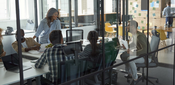 Professionals in a modern office, the type of client who benefits from a Money Market checking account.